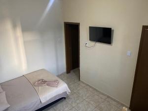 a bedroom with a bed and a flat screen tv at Mega Hotel in Cascavel +12 photos