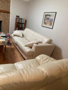 a living room with two white couches at Knight play Golf court house in Apex