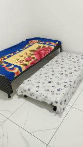a bed sitting on top of a white floor at Apartamento Solar dos Pampas in Guaíba