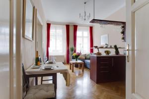 a living room filled with furniture and a kitchen at Prague Siesta Apartments in Prague