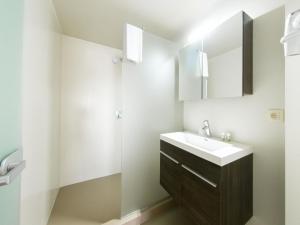 a bathroom with a sink and a mirror at Deluxe superior apartment in Antwerp in Antwerp