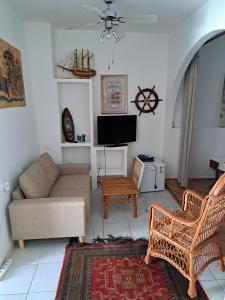 a living room with a couch and a tv at Apartments by the sea Podaca, Makarska - 19078 in Podaca