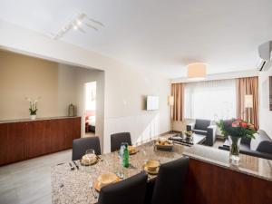 a living room with a table and chairs in a room at Deluxe apartment with wifi in Antwerp in Antwerp +5 photos