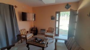 a living room with two chairs and a table at Aires de pedemonte mendocino in Las Heras