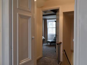 a hallway with a door leading into a room at The Haven in Holy Island +13 photos
