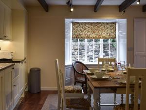 a dining room with a table and a window at The Haven in Holy Island