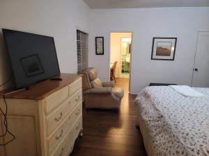 a bedroom with a dresser with a flat screen tv on it at Huge Beautiful house Excellent location in Fresno