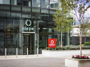 an office building with a sign in front of it at Aparthotel Adagio London Brentford in Brentford