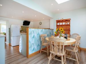 a kitchen and dining room with a table and chairs at Trelawney Cottage in Charlestown