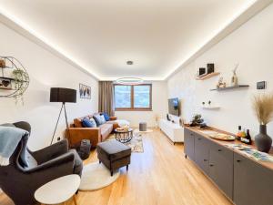 a living room with a couch and a table at Apartmán Na Pomezí in Valtice