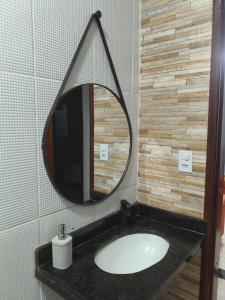 a bathroom with a sink and a mirror at Imóvel em Três Marias in Três Marias +14 photos