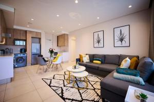 a living room with a couch and a table at Sandtongate Heights in Johannesburg