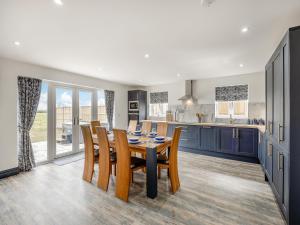 a kitchen and dining room with a table and chairs at Cowslip Cottage - Uk47072 in Maltby le Marsh