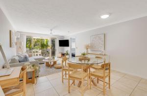 a living room with a table and chairs at Tugun Bliss in Gold Coast