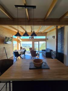 a dining room and living room with a large wooden table at Casa Río de Mozzi in Castro