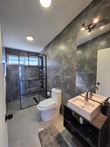 a bathroom with a toilet and a sink and a mirror at Casa Río de Mozzi in Castro +37 photos