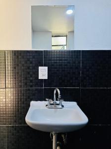 a white sink in a bathroom with a mirror at Vicalis Hotel, Villas y Glamping in San Sebastian Xolalpa