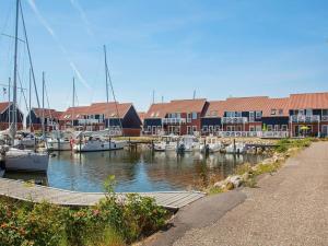 a group of boats docked in a marina with buildings at Holiday home on the harbour in Borre in Borre