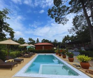 a swimming pool with lounge chairs and a house at Guitar Thai Style Pool House in Ao Nang Beach