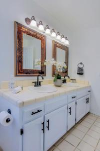 a bathroom with two sinks and two mirrors at Cozy Room#1 Best Moscato in Clovis