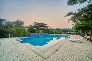 a swimming pool in the middle of a resort at Vintage Trails By Ilara in Alūr