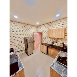 a kitchen with a refrigerator and a counter top at Lexworld Hotels in Aba