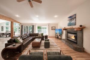 a living room with a couch and a fireplace at Emerald Lodge at Tahoe Park by Tahoe Getaways - 4BR w HOA Beach & Air Conditioning in Tahoe Park