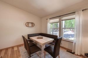 a dining room with a table and chairs and a window at Emerald Lodge at Tahoe Park by Tahoe Getaways - 4BR w HOA Beach & Air Conditioning in Tahoe Park +34 photos