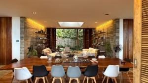 a living room with a wooden table and chairs at Chalet, Free Suzuki Jimny 4x4, Port pick-up and drop-off service, and Unlimited Massage Chair Use in Maria