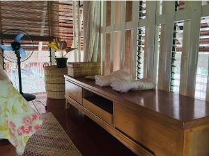a wooden dresser with a statue on top of it at Chalet, Free Suzuki Jimny 4x4, Port pick-up and drop-off service, and Unlimited Massage Chair Use in Maria