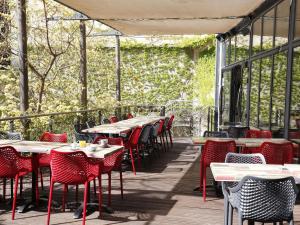 a row of tables and chairs on a patio at Hôtel Marseille Centre Gare Saint-Charles in Marseille