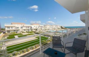 a balcony with two chairs and a view of the ocean at Cozy Apartment In Marzamemi With Wifi in Marzamemi