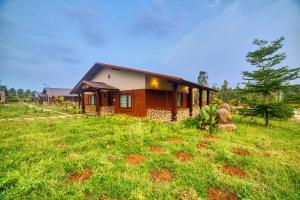 a house on a hill with a green field at Vintage Trails By Ilara in Alūr