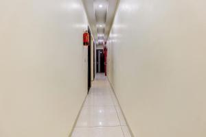 an empty hallway in a building with white walls at Hotel O La Vista in Zirakpur