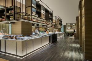 a kitchen with a counter with food on it at Chengdu Marriott Hotel Financial Centre in Chengdu