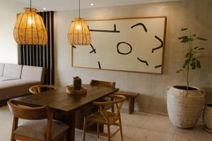 a living room with a table and a clock on the wall at Dream Haus Country Club in Guadalajara +117 photos