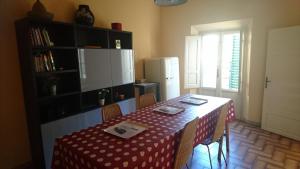 a kitchen with a table with a red and white table cloth at Francesca House in Pisa