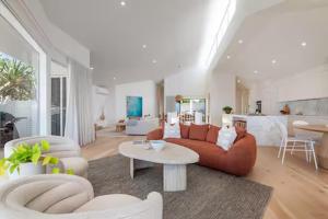 a living room with a couch and a table at Seaviews at Sunshine Beach 4BR, Pool in Sunshine Beach