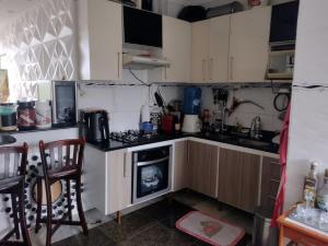 a kitchen with white cabinets and a stove top oven at Apartamento Classic in Belém