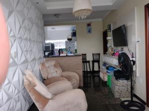 a living room with two chairs and a fireplace at Apartamento Classic in Belém