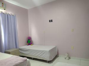a bedroom with two beds and a stuffed animal on the bed at Apartamento Classic in Belém