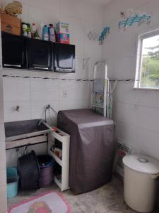 a small bathroom with a sink and a toilet at Apartamento Classic in Belém