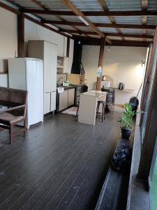 a kitchen with a white refrigerator and a table at Casa Bernardo in São José