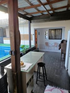 a kitchen and living room with a table and chairs at Casa Bernardo in São José