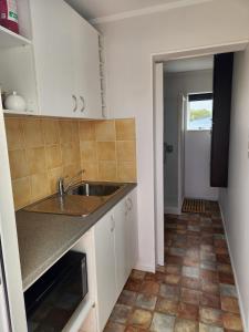a kitchen with a sink and a counter top at Cosy Studio Unit on Longview in New Plymouth