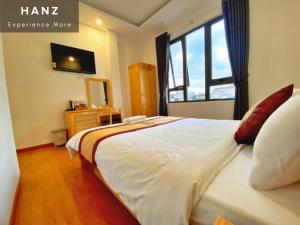 a bedroom with a large white bed with a window at S79 Hoa Dang Dalat in Da Lat