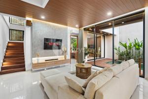 a living room with a couch and a tv at Santari Villa by Kozystay - Canggu in Pererenan +47 photos
