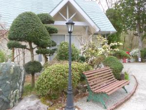 a park bench next to a lamp post in front of a house at Sun Terrace Hakone in Hakone