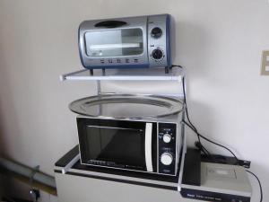 a microwave and a toaster oven on a shelf at Sun Terrace Hakone in Hakone +20 photos