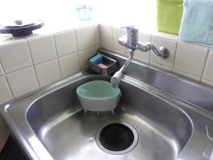 a sink with a faucet and a bowl in it at Sun Terrace Hakone in Hakone
